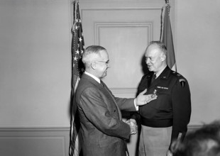 U.S. President Harry S. Truman (left) presenting U.S. General Dwight Eisenhower (right) with the