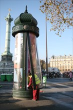 France, Paris 4e - place de la bastille - changement d'affiche dans une colonne morris
