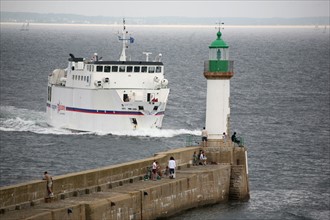 France, Bretagne, Morbihan, ile de groix, ferry arrivant a port tudy, digue, phare, ciel menacant,