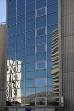 France, reflections in a glass building