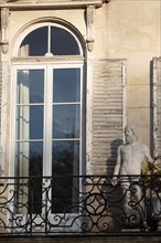 Paris, sculpture on the balcony of a building