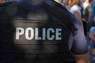 Police logo on the back of a uniformed officer