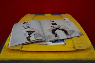 Paris, fashion magazine open on a dustbin