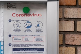 Paris, information panel on coronavirus in front of a school