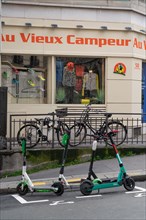 Paris, bicycles and scooters in front of Le Vieux Campeur shop