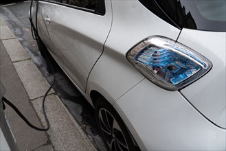 Paris, electric car plugged in a charging station