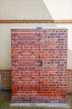 Luneray, electrical cabinet with trompe l'oeil bricks