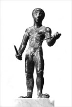 Naked man holding two daggers -