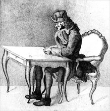 Voltaire à sa table de travail.