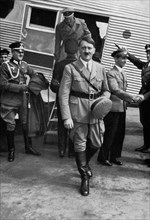 Adolf Hitler getting off an aeroplane.