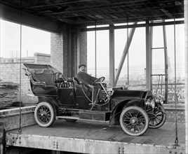 A car and chauffeur in the car lift at Mitchell's Motors, Wardour Street, London, 1907