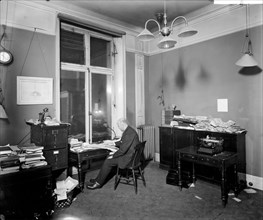 An editor working late in the Morning Post offices at Inveresk House, Westminster, London, 1920