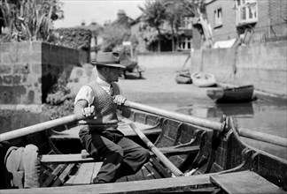 Man rowing the Twickenham ferry boat, Twickenham, c1945-c1965