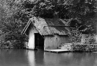 Wooden boathouse beside the River Rother, Woolbeding, West Sussex, c1900