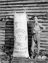 Man with hop sack at Great Dixter, East Sussex, 1933