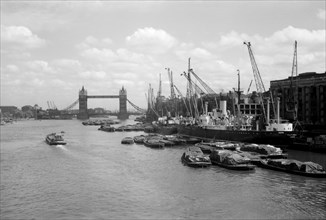 Tower Bridge with shipping in the Pool of London and at Hay's Wharf, Southwark, London, c1945-c1965