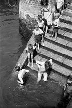 Children bathing in the River Thames, Tower Pier approach, Stepney, London, c1945-c1965