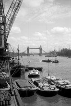 Tower Bridge with shipping in the Pool of London and vessels at Hay's Wharf, Southwark, c1945-c1965