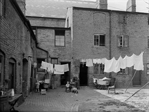 Children in a run-down courtyard, Warwickshire, 1946