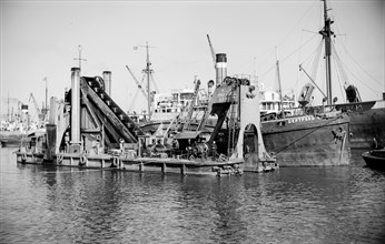 A dredger moored in Tilbury Docks, Essex, c1945-c1965