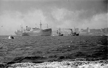 The 'Stanhill' is escorted by tugs, c1945-c1965