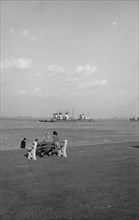 Two holidaymakers look out to sea on the promenade at Gravesend, Kent, c1945-c1965