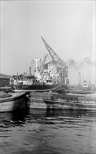 A crane unloading cargo from the 'Makalla' in Tilbury Docks, Essex, c1945-c1965