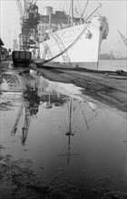 The 'Strathaird' reflected in a puddle at Tilbury Docks, Essex, c1945-c1965