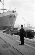 Port of London Authority policeman on patrol, c1945-c1965
