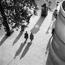 Pedestrians on the Victoria Embankment, London, seen from Waterloo Bridge