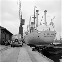 A ship unloading in West India Docks, London, c1945-c1965