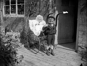 Child with a baby in a pram, Hellidon, Northamptonshire, 1900