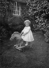 Child on a wooden horse, c1896-c1920