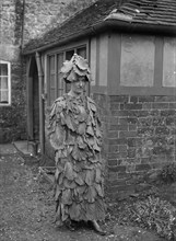 A woman in a cabbage leaf costume, Hellidon, Northamptonshire, c1896-c1920