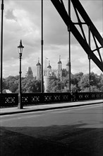 The Tower of London, viewed here through the cable supports of Tower Bridge, c1945-c1965
