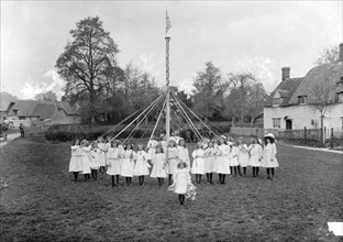 Children dance around the village maypole, East Hanney, Oxfordshire, c1860-c1922