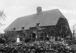 Thatched cottage with women standing outside, Shellingford, Oxfordshire, c1860-c1922