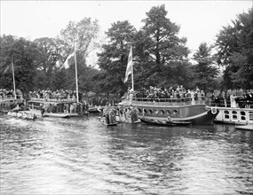 Spectators on the University barges watching a boat race during Eights Week, Oxford, c1860-c1922