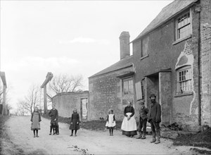 Family outside their cottage with the canal bridge in the background, Uffington, Oxfordshire, 1916