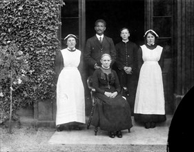 Domestic servants posing outside Pembroke College, Oxford, Oxfordshire, c1860-c1922
