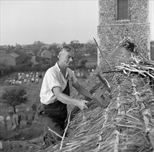 Thatching the roof of St Margaret & All Saints church, Pakefield, Suffolk, 1949