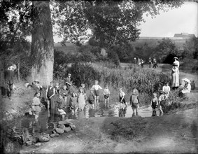 Children playing in a pool on a hot summer's day, Cowley, Oxford, Oxfordshire, 1914