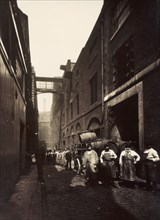 Brewery workers outside the Combe & Co's Brewery, Castle Street, St Giles Circus, London, c1875. Artist: Unknown