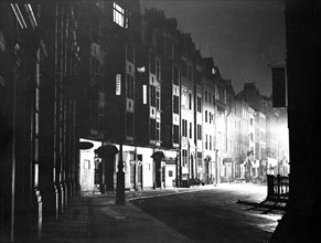 Street scene at night, Tottenham Court Road, Camden, London. Artist: Unknown