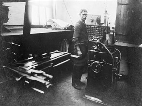Man in a printing workshop, (late 19th-early 20th century?). Artist: W Martin