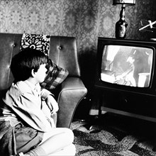 Boy watching television in a London house, c1950s. Artist: Henry Grant