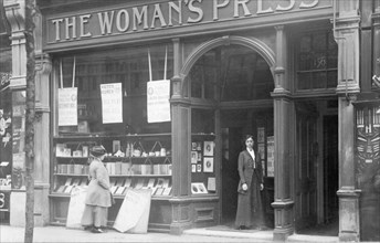 Mrs May looking in the window of the Woman's Press shop, London, 1910. Artist: Unknown