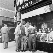 Men outside a menswear shop, London, late 1950s. Artist: Henry Grant