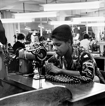Woman working at a sewing machine, London, (c1955-c1975?). Artist: Henry Grant