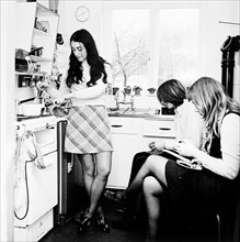 Three young people in the kitchen of a London flat, c1960s. Artist: Henry Grant